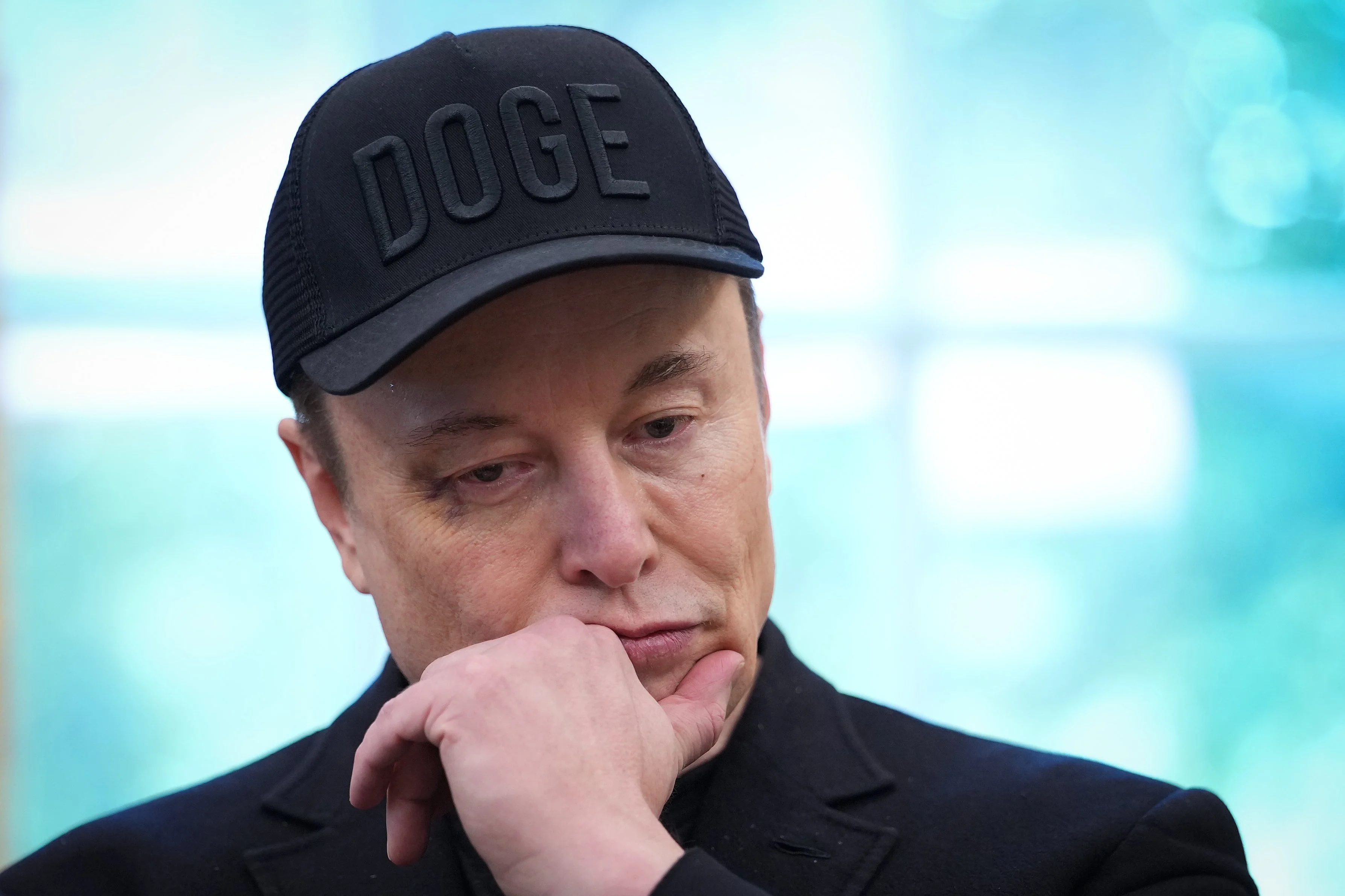 Elon Musk wearing a DOGE cap